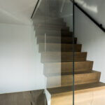 Glazen plafondhoge wand aan trap